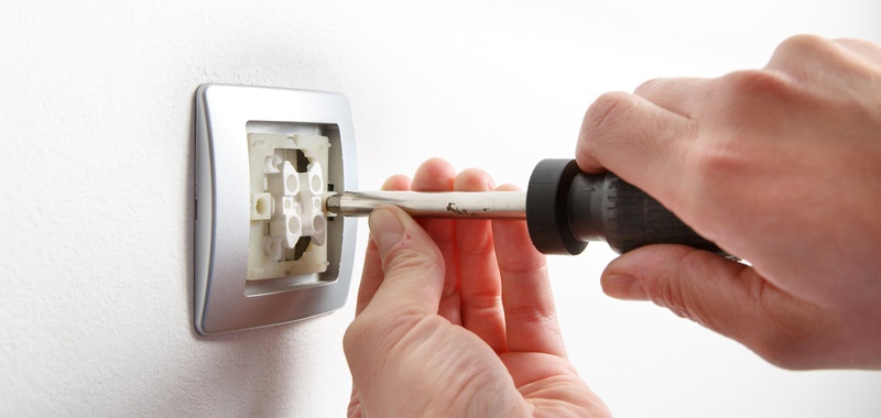 Electrician installing a light switch